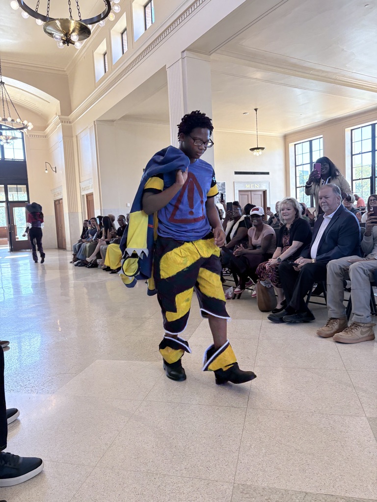 Ahmad Williamson and Julian Stockton work on fashion designs and showcase their completed pieces at Winston Salem Fashion Week.