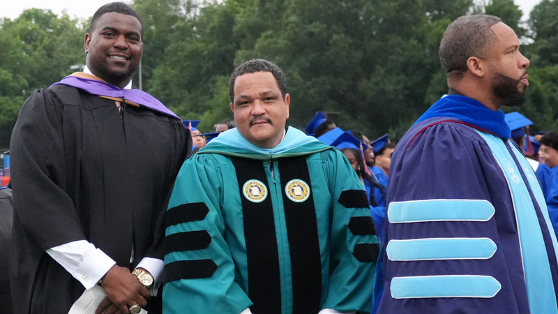 Keynote speaker Cory Holt, Superintendent Dr. Ron Anthony, and Lexington Senior High School Principal Dr. Jermaine Porter pose together during Lexington Senior High School's Class of 2026 graduation ceremony.