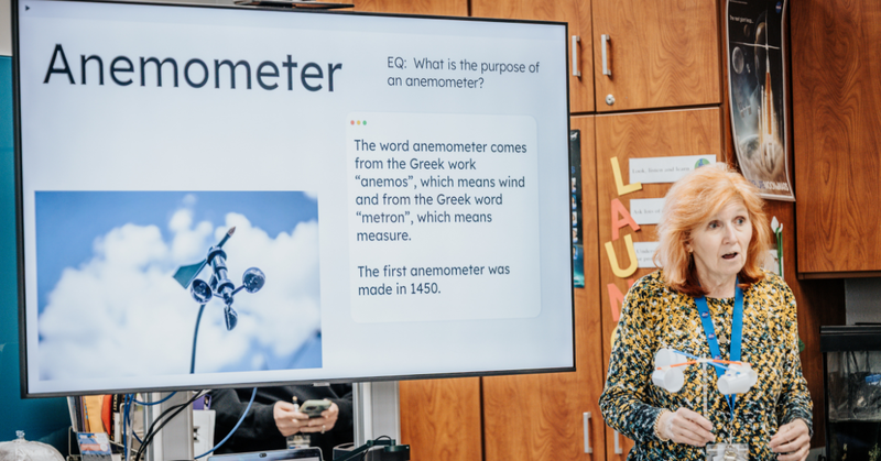 Charles England Elementary School teacher presents a science lesson about anemometers using a classroom display.