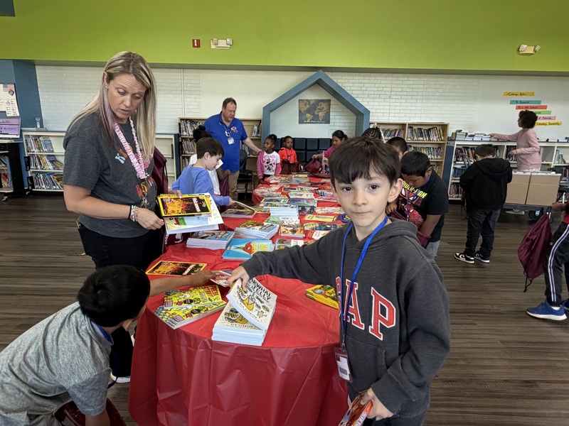 Students select and take home books during the Books on Break event, expanding access to literacy beyond the classroom.