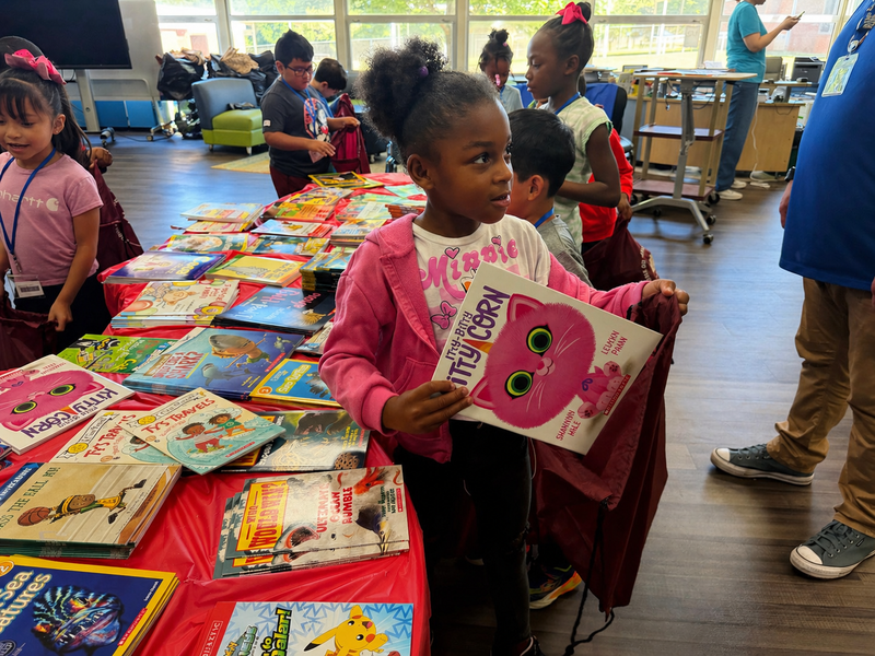 Students select and take home books during the Books on Break event, expanding access to literacy beyond the classroom.