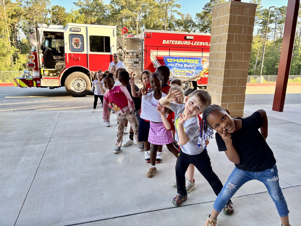 Pic of students with firetruck in background