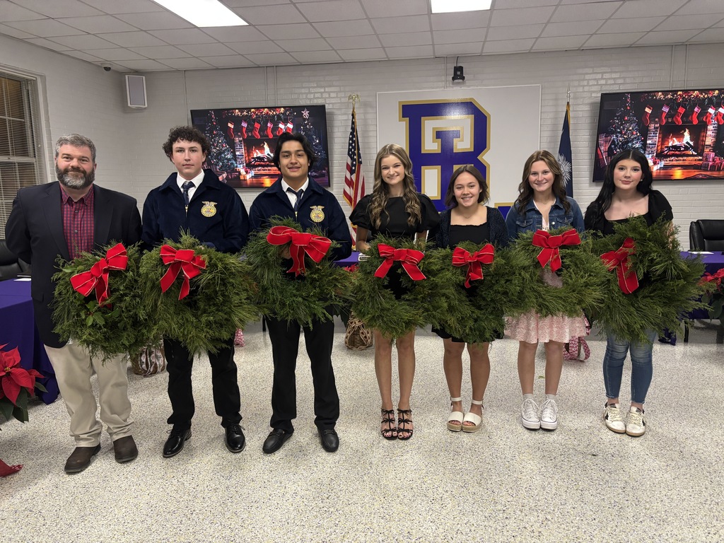 FFA students holding wreaths