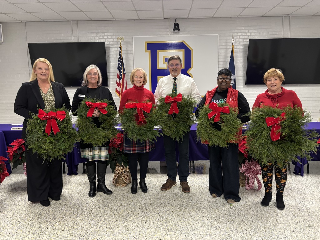 Board of Trustees members holding wreaths