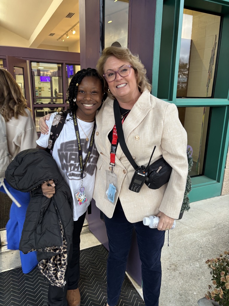 Student and principal smiling after winter break