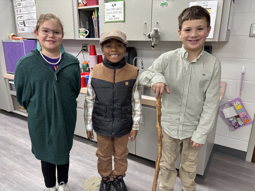 Students smiling on the 100th day of school