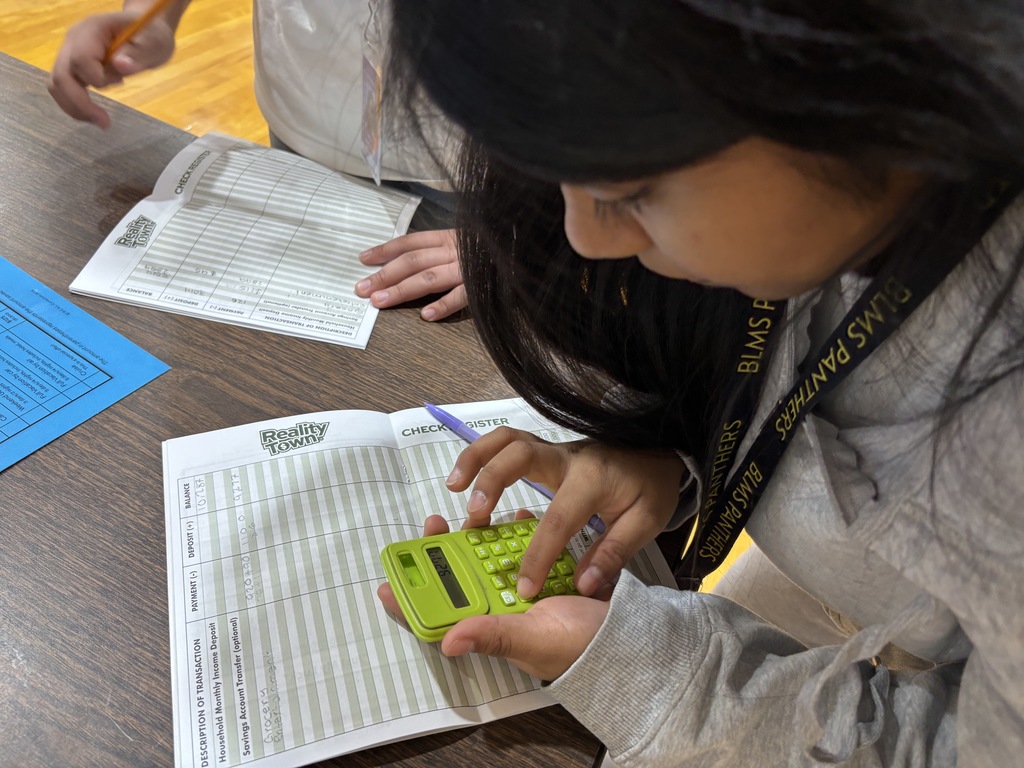 Picture of student using a calculator at Reality Town simulation