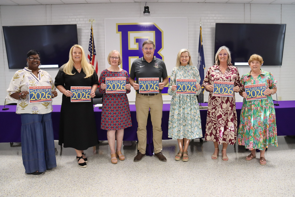 Board of Trustees holding signs from SCSBA