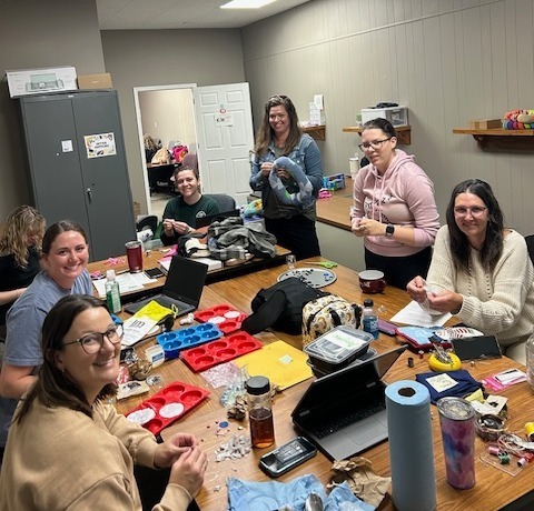 Therapists at work on  picky pads, button strips and weighted materials for kids and classrooms