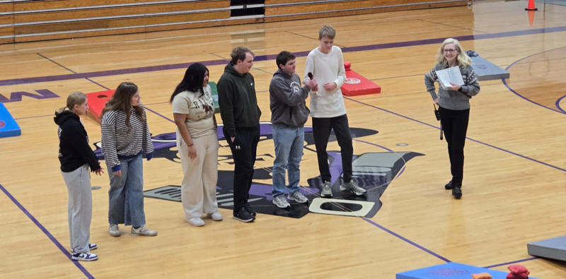 Students standing at an assembly