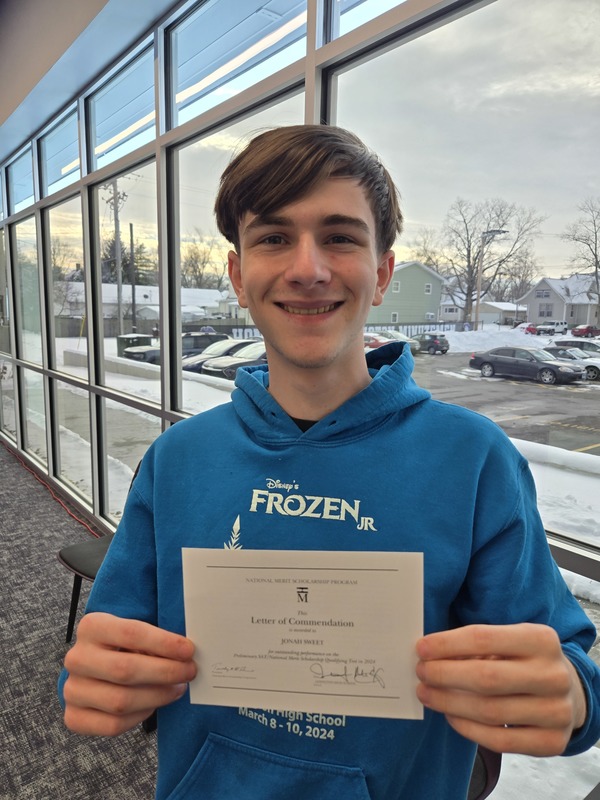 student holding an award