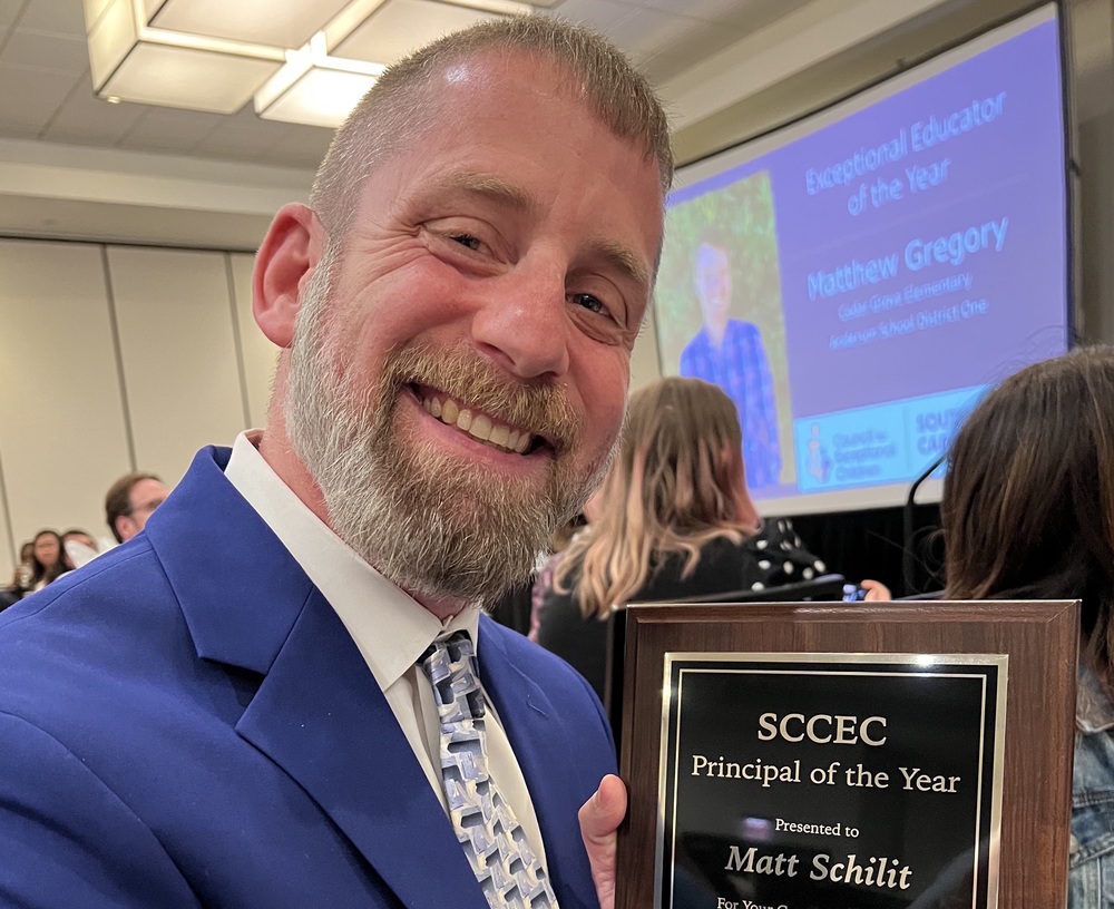 Principal Matt Schilit with award