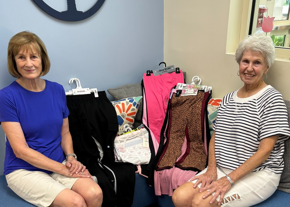 Two ladies with clothes donations