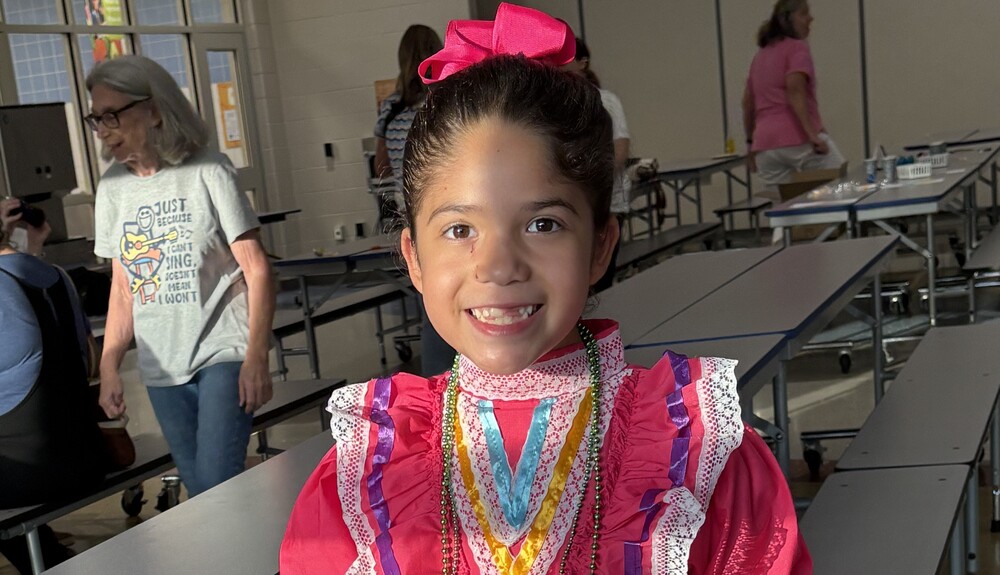 Child holding a Mexican Flag