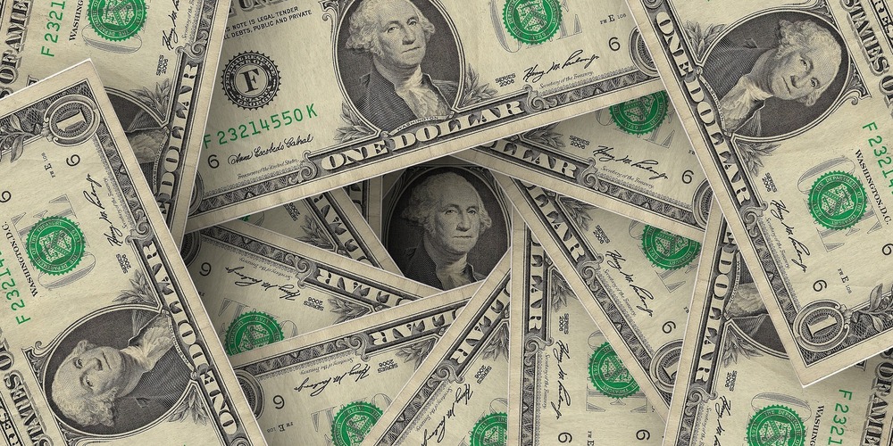 A pile of scattered dollar bills, face-up