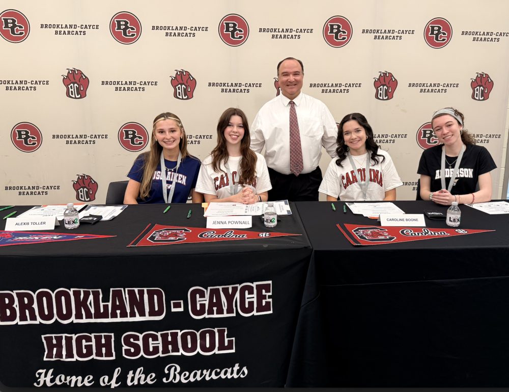 From left, Alexis Toller, Jenna Pownall, Caroline Boone, and Emily Crow, all named SC Teaching Fellows, participated in a Future Teachers Signing Day at Brookland-Cayce High School. Terry Boone, the school’s Teacher Cadet instructor, stands with them.