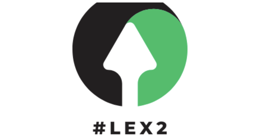 Circle,with black on one side, green on the other, white arrow pointing up in the middle, with hashtag #LEX2 at  bottom