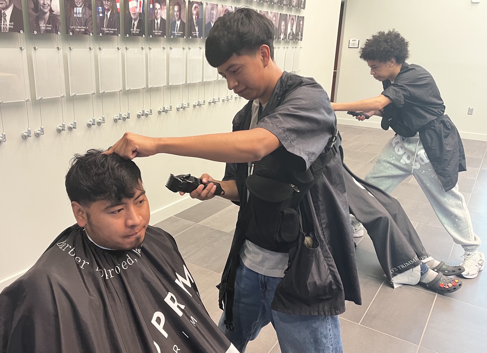 Barbering students cut hair at Lexington Two’s Hispanic Heritage Celebration last fall.