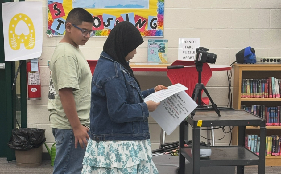 Students look over scripts for the Morning Show