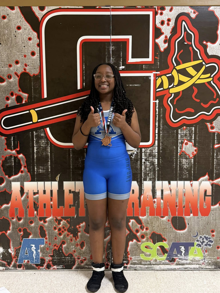 female wrestler wearing blue singlet