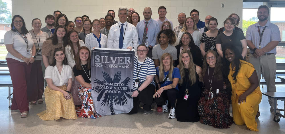 Fulmer teachers and staff, with Palmetto Silver banner