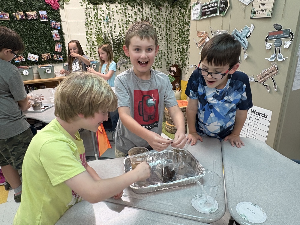 Students enjoy a classroom experiment with soil