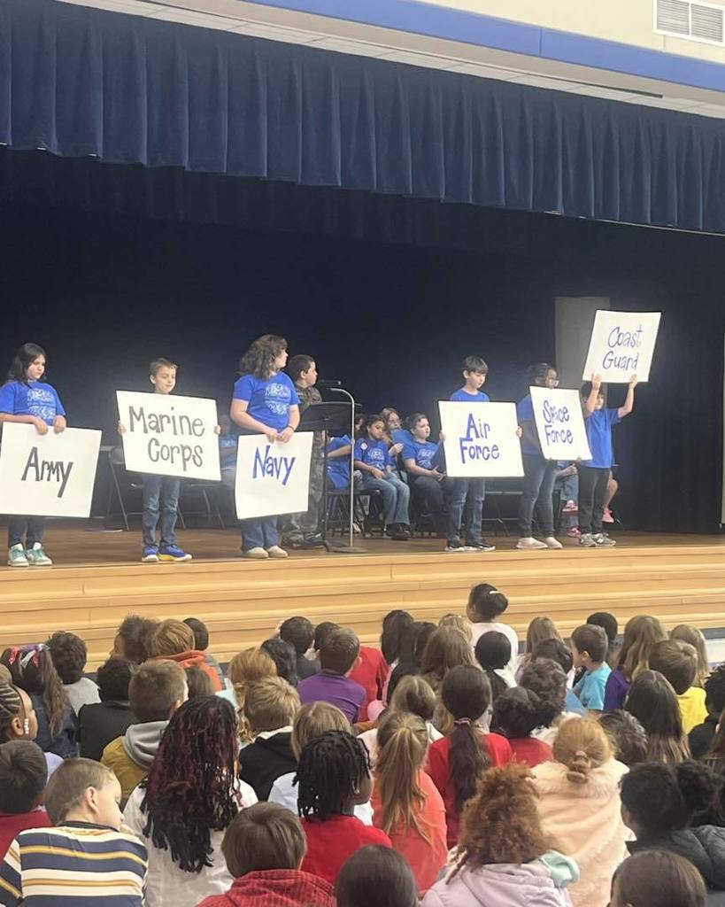kid holding sign for Veteran's Day