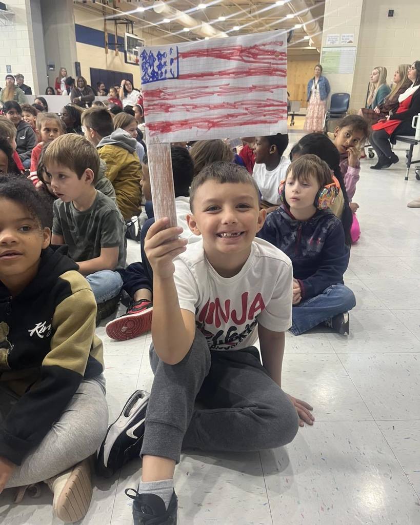 kid holding sign for Veteran's Day