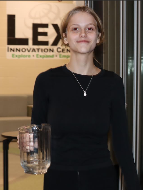 One of the students holds a water pitcher