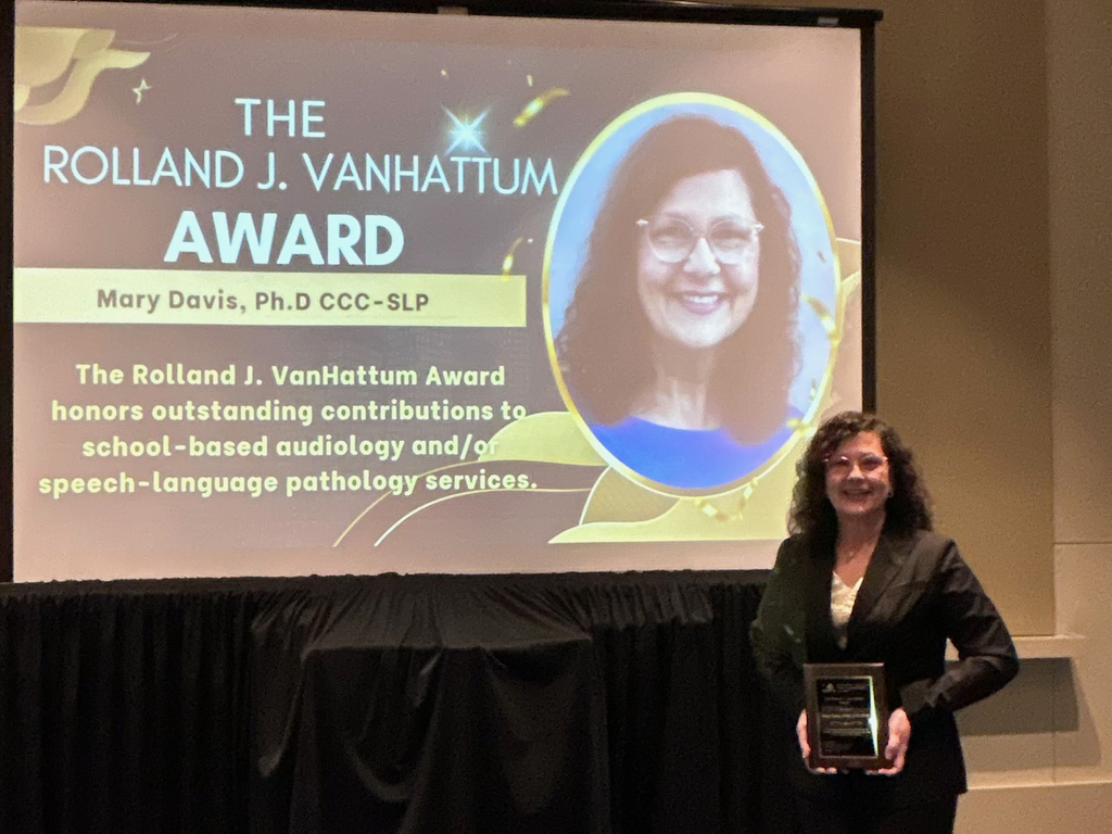 Dr. Davis holding The Rolland J. Vanhattum Award that was awarded to a Speech Pathologist for outstanding contributions to School-based audiology and or speech-language pathology services.
