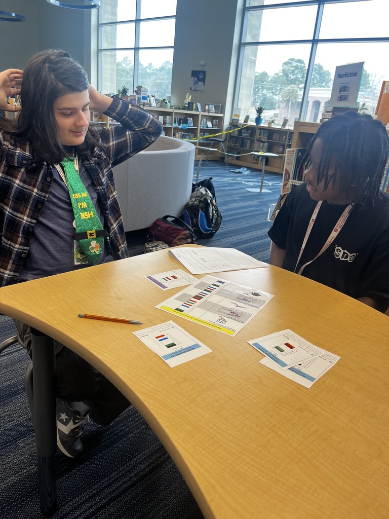 Two students investiage DNA results form a forensics lab to try and identify the criminal in this pretend scenario.