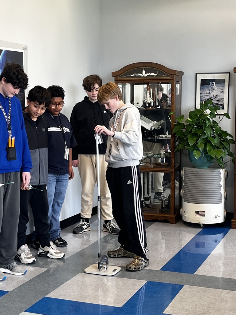 Students begin testing out their paper straw rockets.