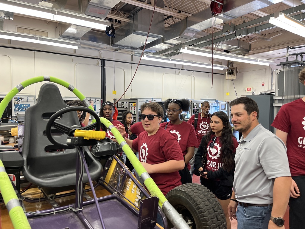 Students viewing a go cart.