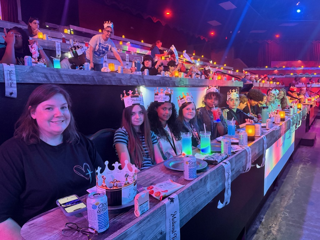 Students seated at tables waiting for the Medieval Times Show to begin.