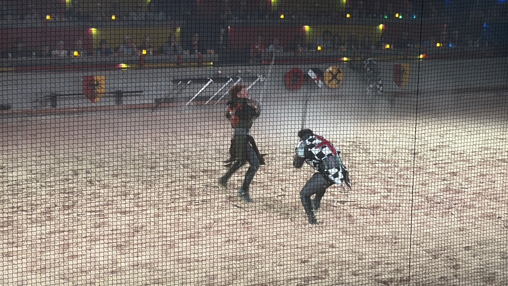 Two members from the Medieval Times show are shown on the sand sword fighting.