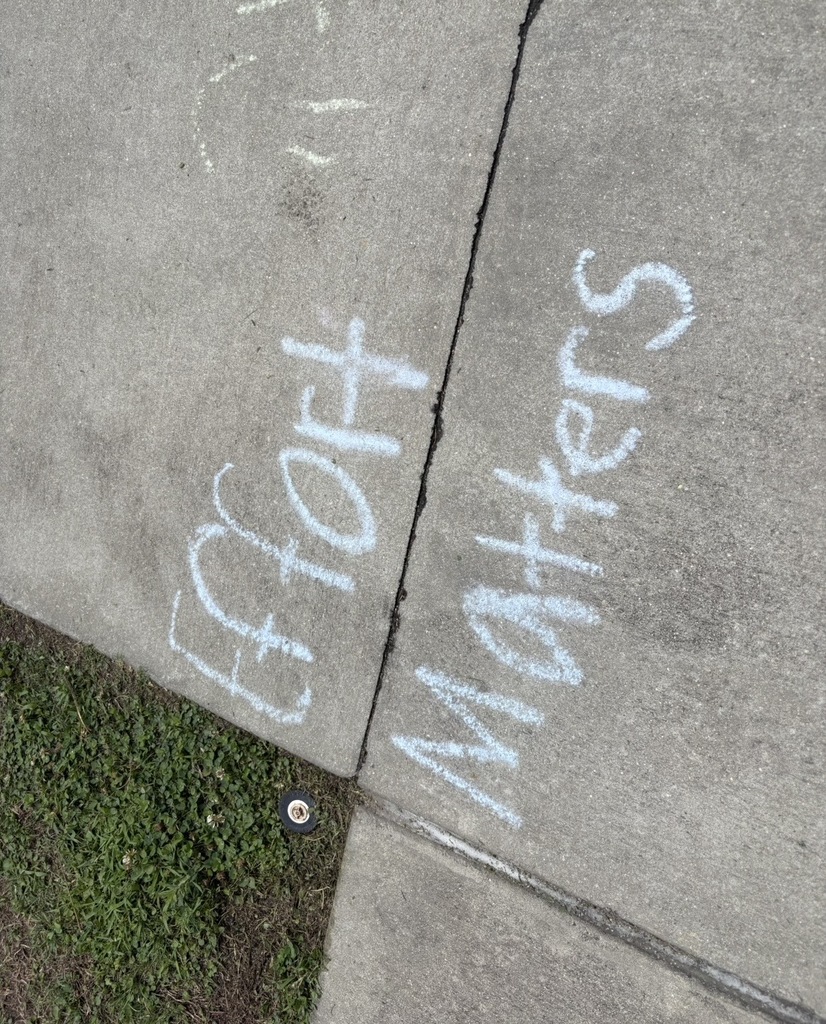 Sidewalk chalk states, "Effort Matters."