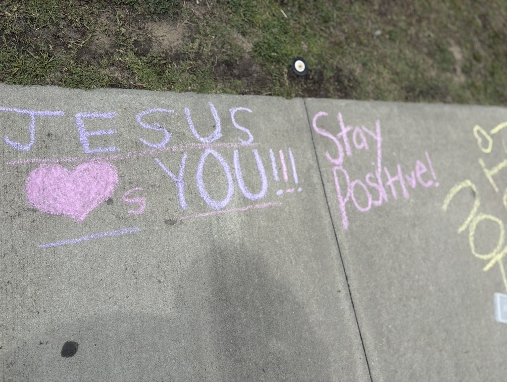 Sidewalk chalk states, "Jesus -heart symbol with a letter S after the heart- YOU!!!" and "Stay Positive!"