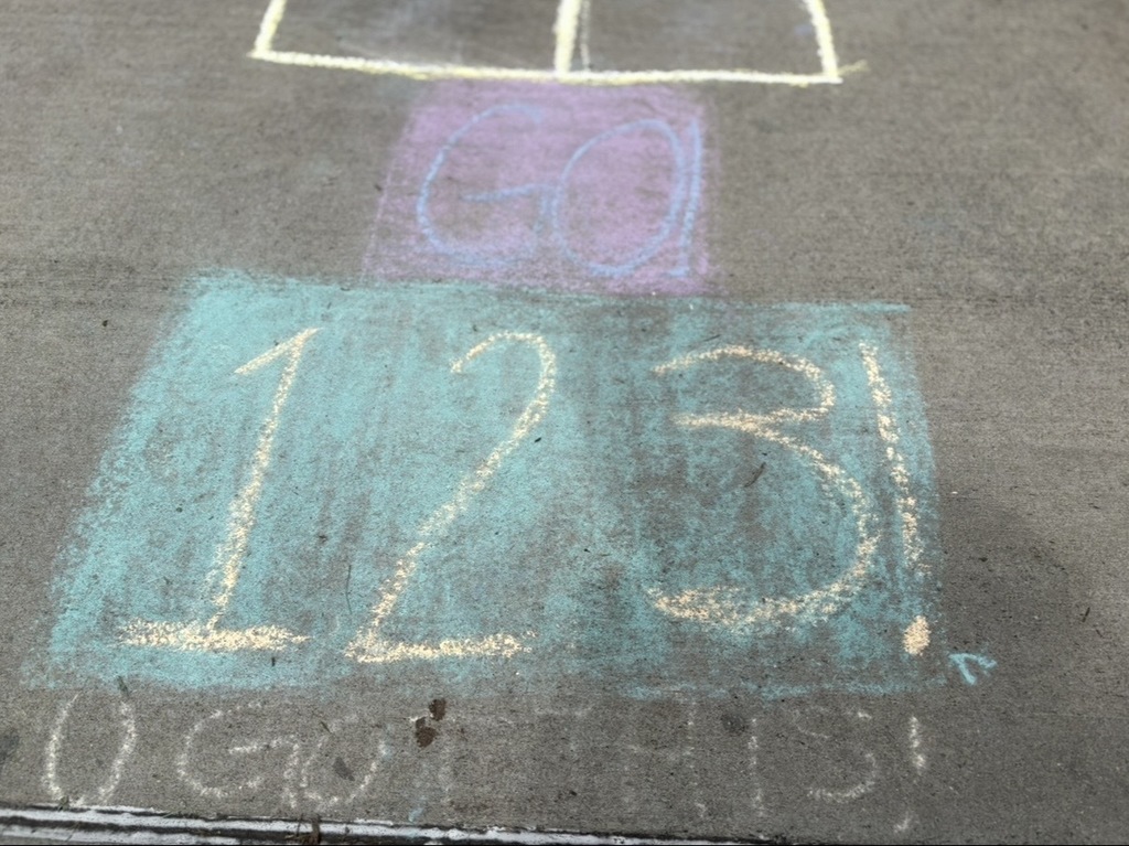 Sidewalk chalk states, "GO 123 U GOT THIS!"