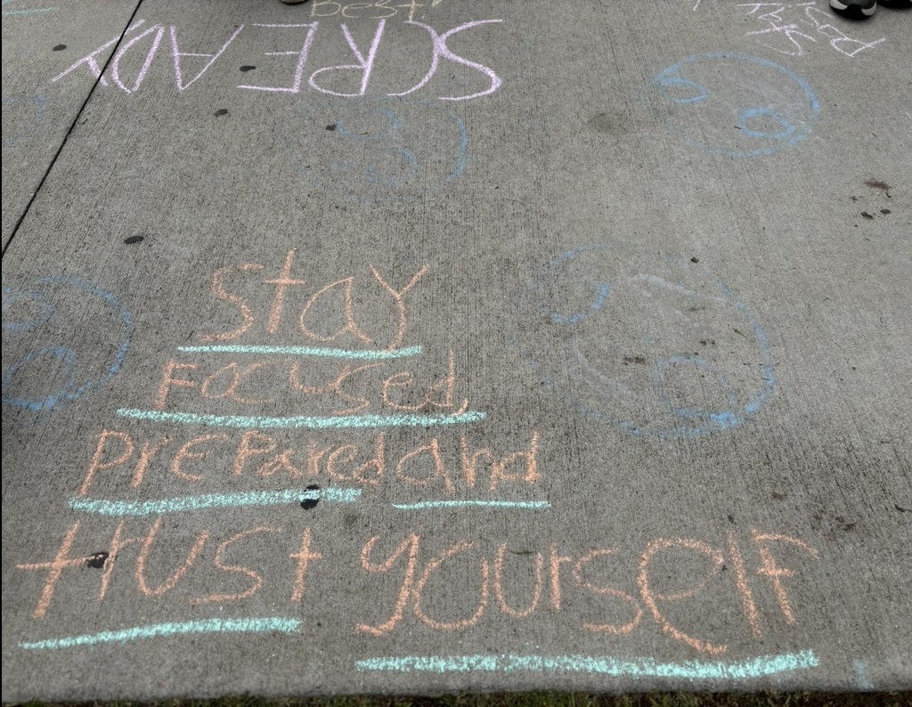 Sidewalk chalk states, "Stay focused, prepared, and trust yourself."