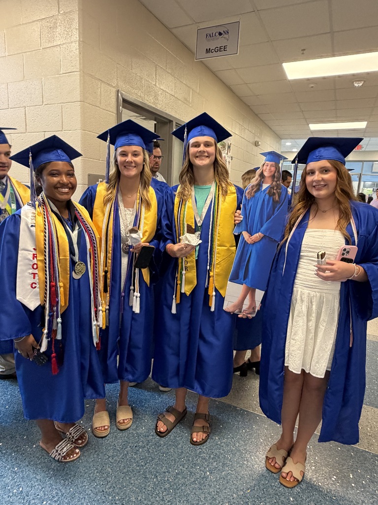 A group of students stand together holding ice cream in their hands after senior walk through.