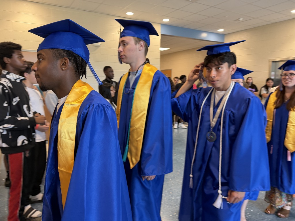Senior graduates walking through the halls of their middle school for senior walk through.