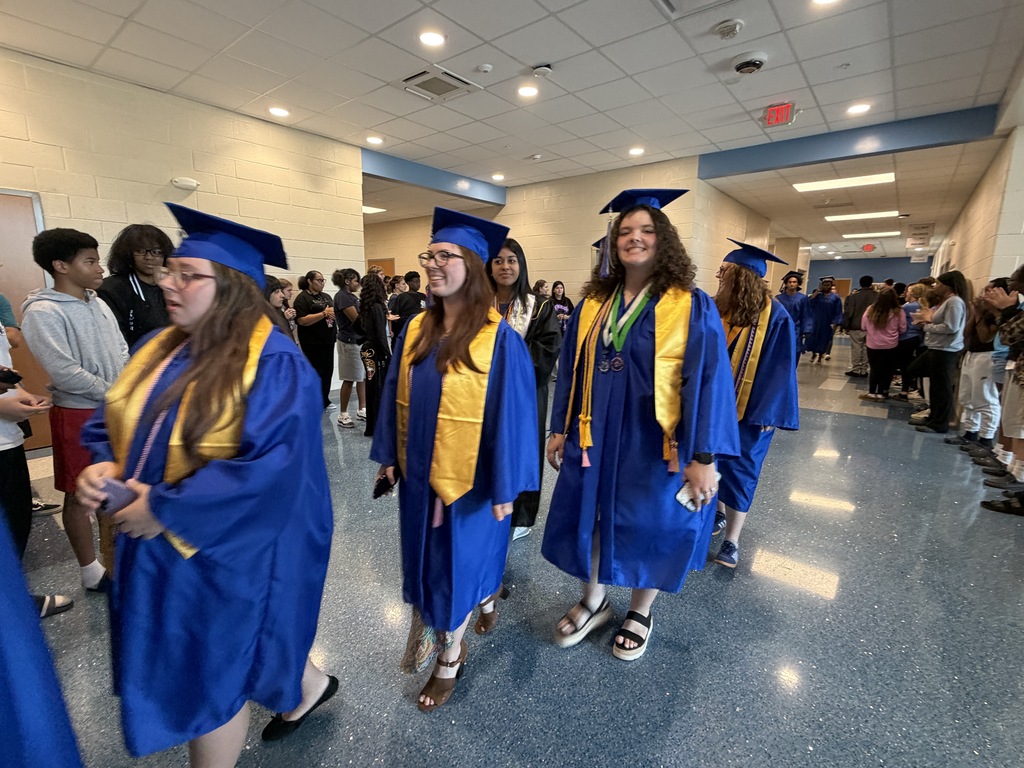 Senior graduates walking through the halls of their middle school for senior walk through.