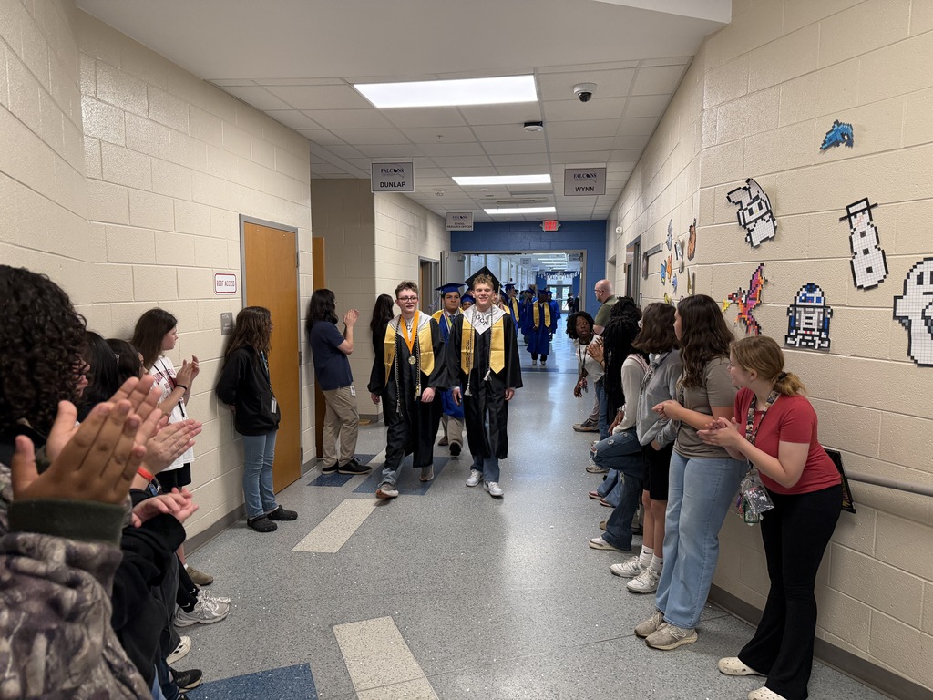 Senior graduates walking through the halls of their middle school for senior walk through.