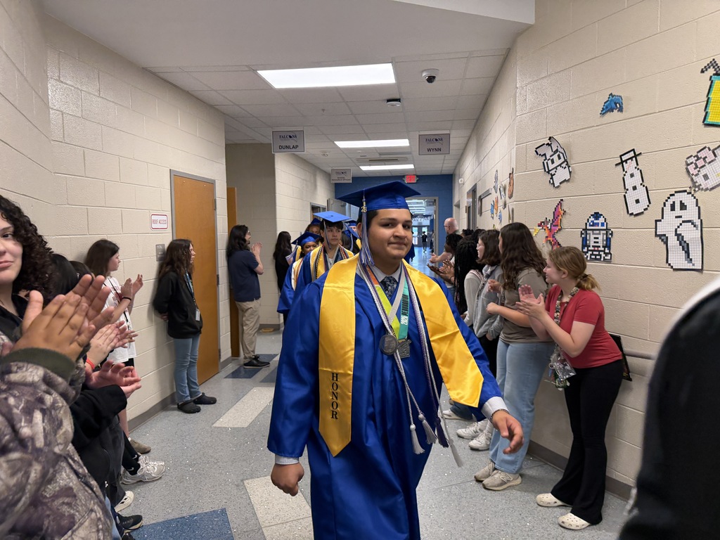 Senior graduates walking through the halls of their middle school for senior walk through.