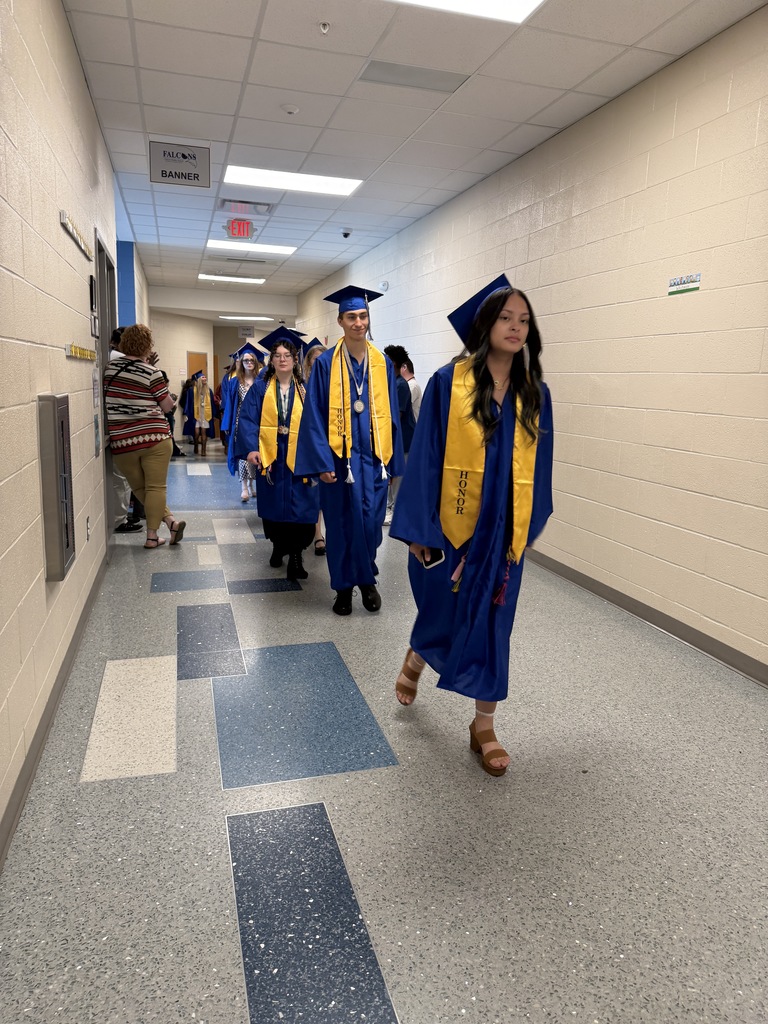 Senior graduates walking through the halls of their middle school for senior walk through.