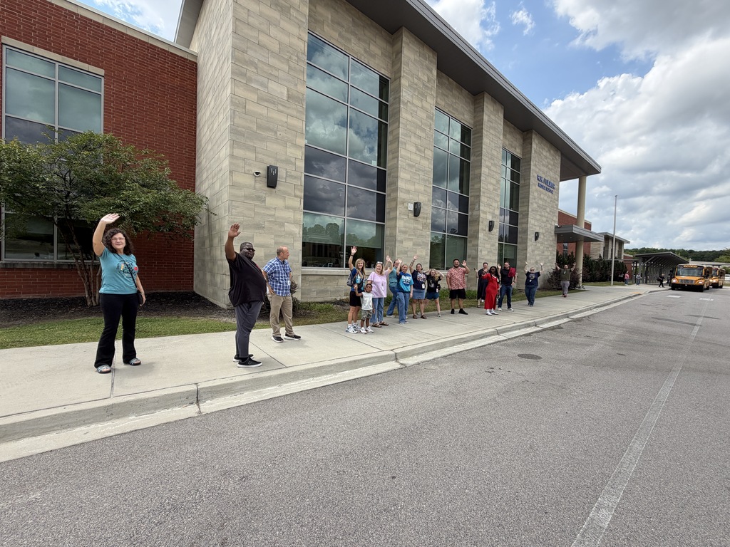 Faculty and staff wave goodbye to students on the school buses leaving Fulmer for summer break.