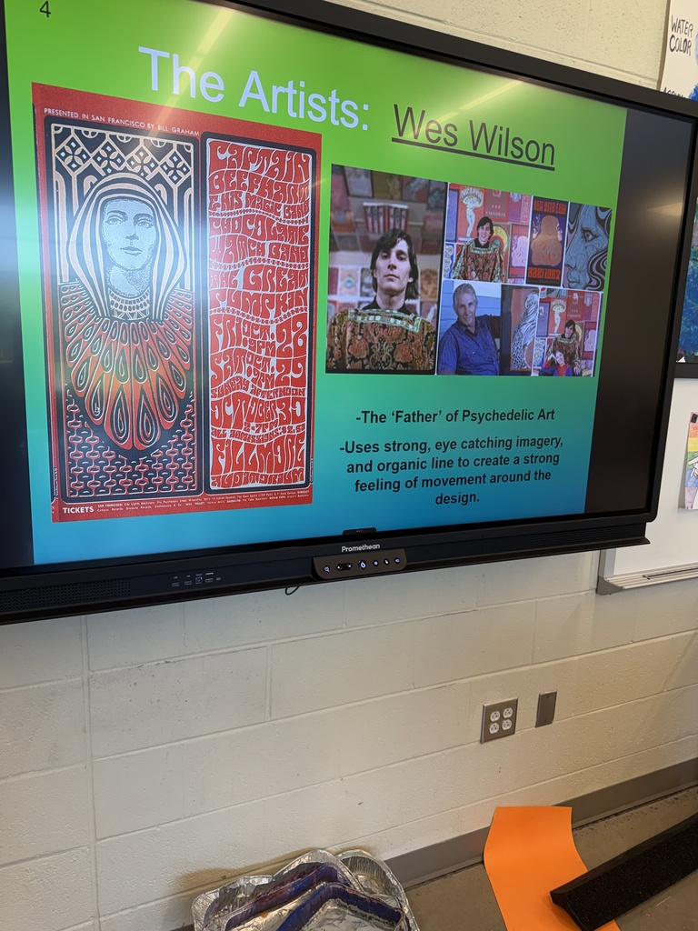 Promethean board in art class displays information about Wes Wilson behind the concept of psychedelic drawings.