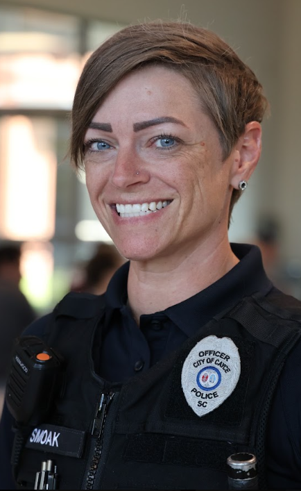 Image of Fulmer's School Resource Officer shown smiling and wearing her police unform. The badge on her left lapel states, "Officer City of Cayce Police SC."