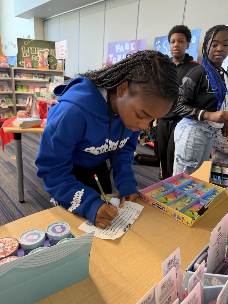 A female student records informaiton on her wish list paper to write what she wants from thebook fair.
