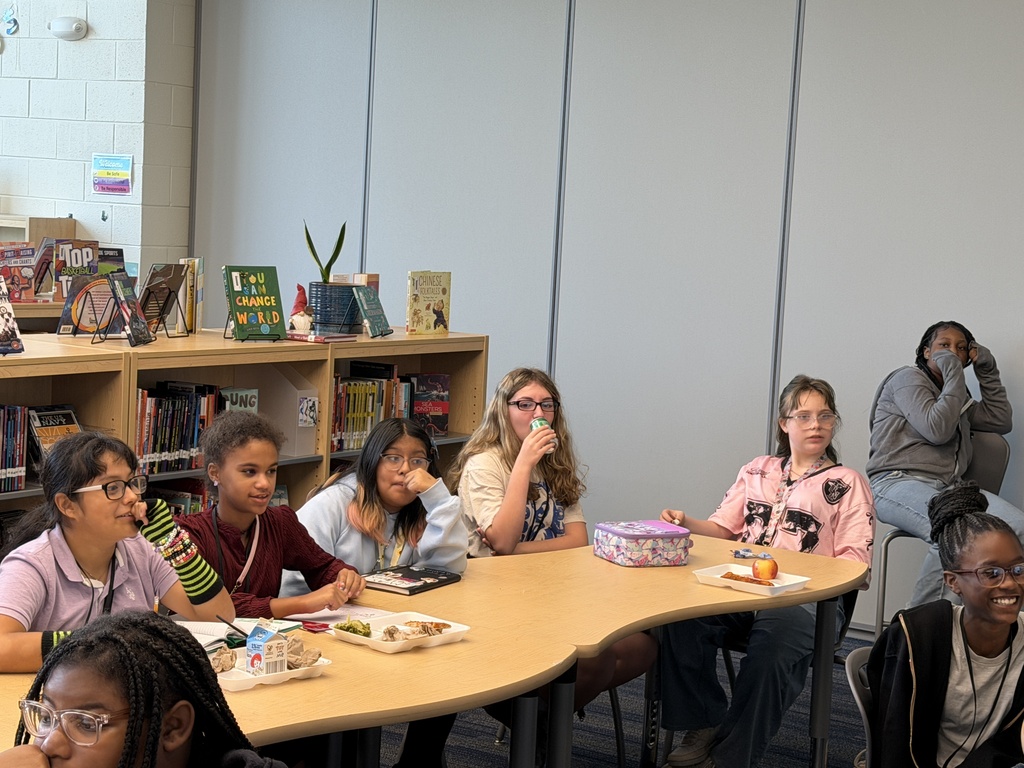Students gathered in the library sitting at tables while eating lunch and participating in the Fulmer library and public library collaboration event.Students gathered in the library sitting at tables while eating lunch and participating in the Fulmer library and public library collaboration event.